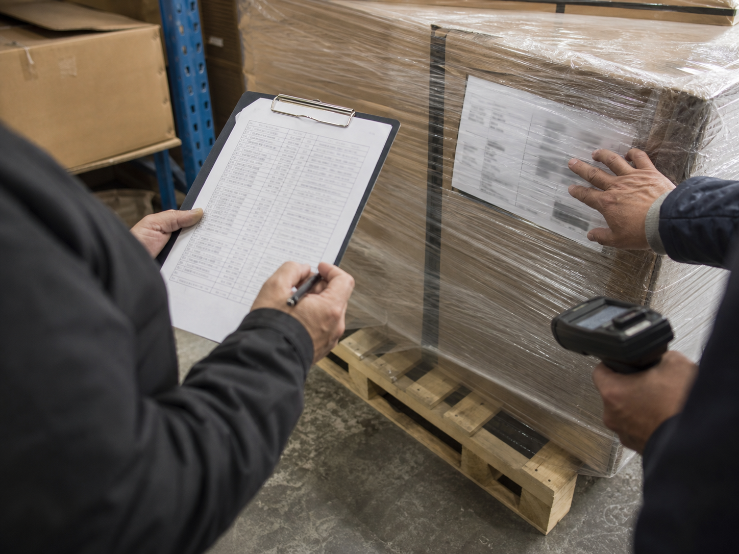Shipment documents being checked beside sealed cargo
